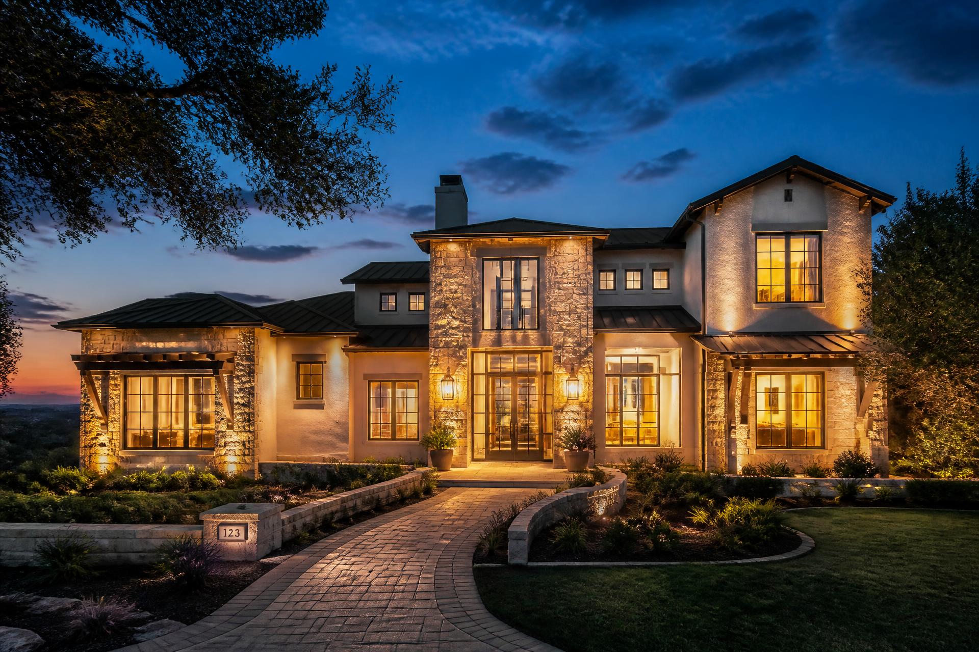 Luxury San Antonio home at dusk with warm interior lighting