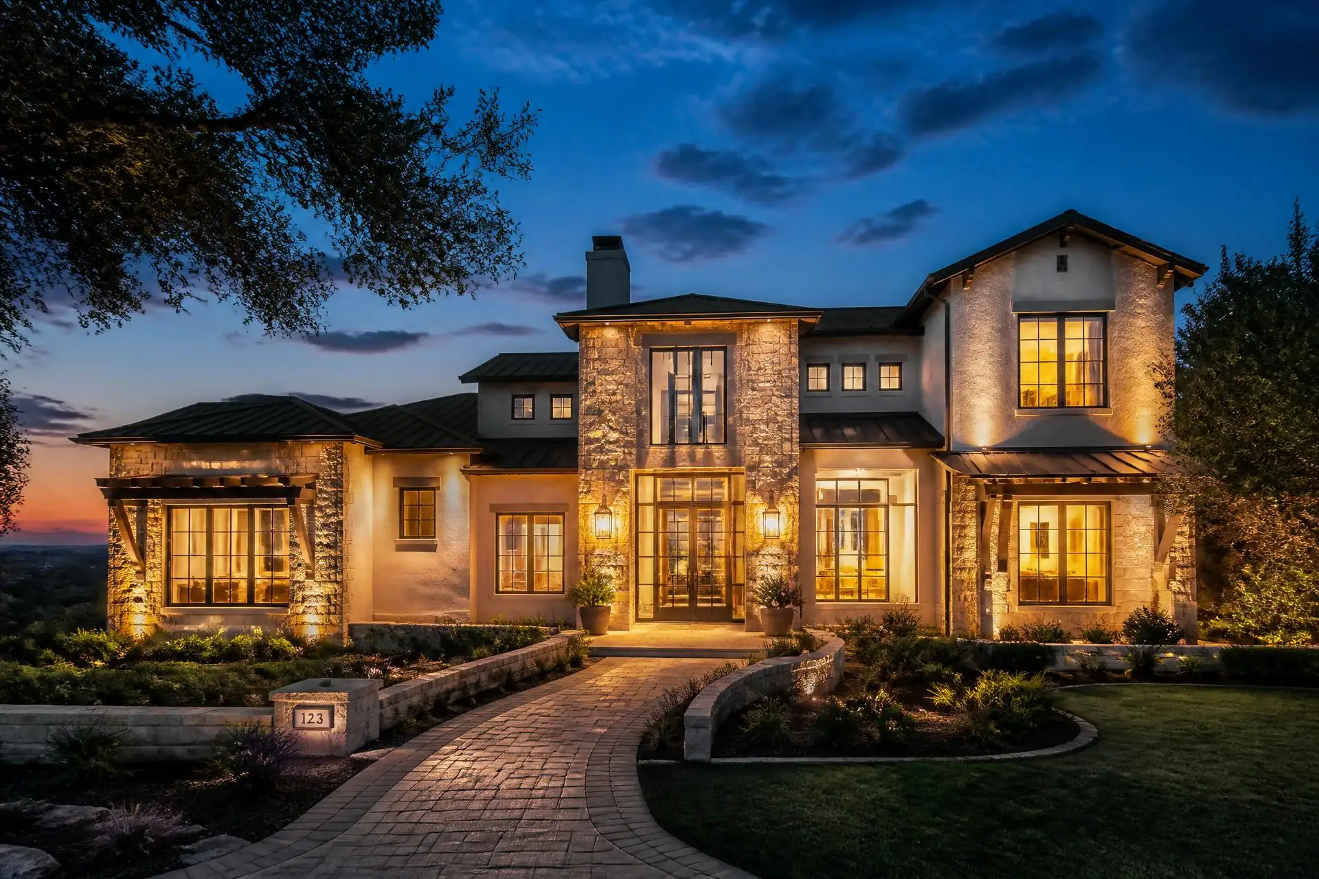 Luxury San Antonio home at dusk with warm interior lighting